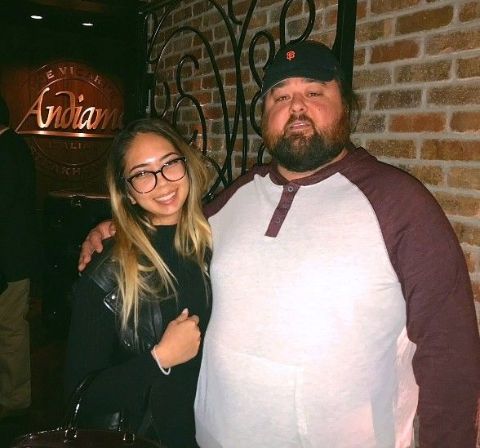 Chumlee in a white t-shirt poses for a picture with wife Olivia Readmann.